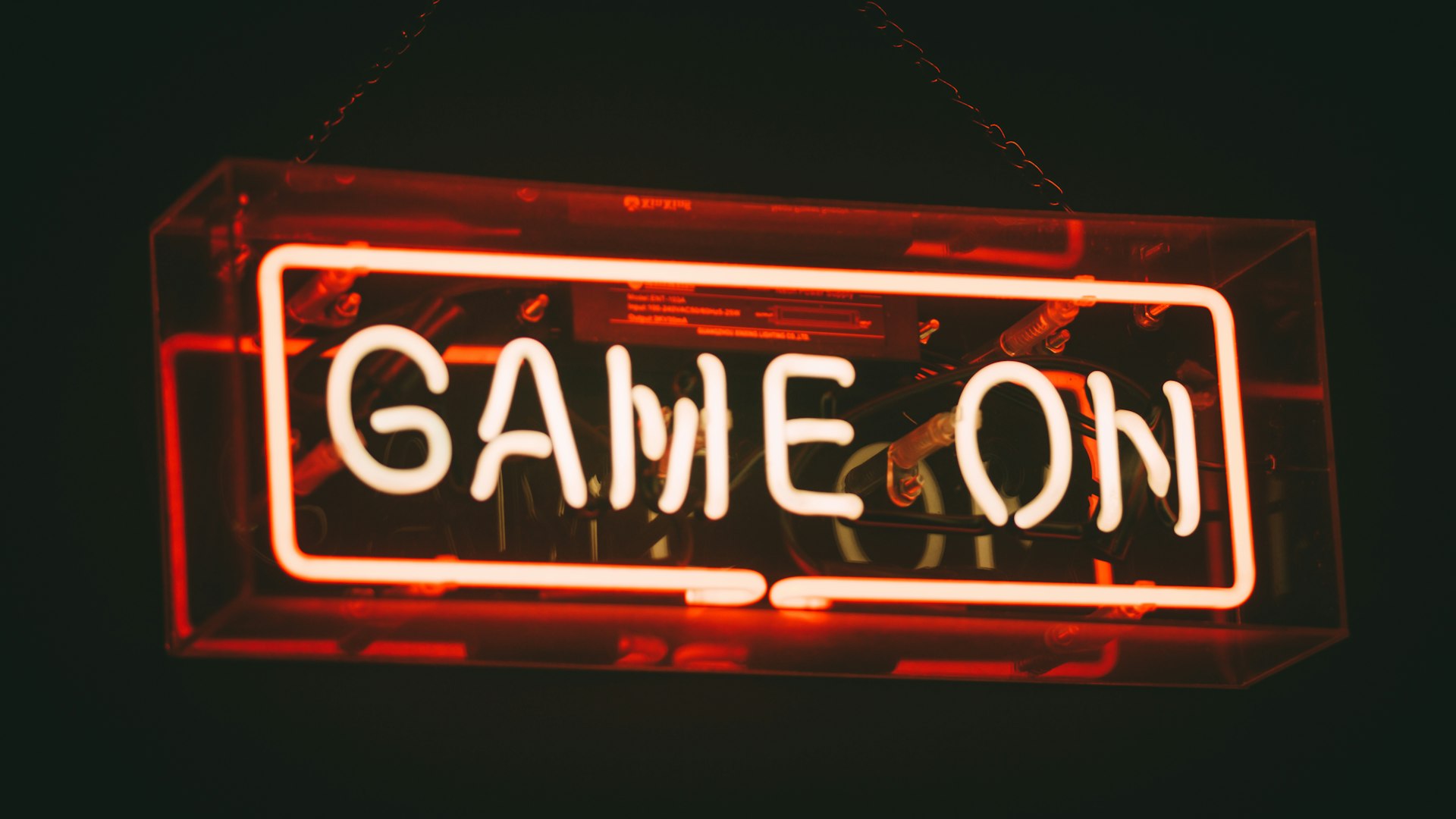 Arcade cabinet glowing in a dark room